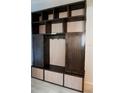 Custom mudroom with dark wood cabinets and light wood trim at 14146 Jomatt Loop, Winter Garden, FL 34787