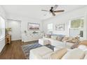 Bright living room with stylish furnishings, plush seating, and a decorative rug over hardwood floors at 16262 Firedragon Dr, Winter Garden, FL 34787
