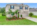 Charming two-story home with landscaped yard, beautiful lawn and a two car garage at 16436 Fernridge St, Clermont, FL 34714