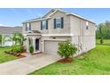Beautiful two-story home with a two car garage, lovely landscaping and a well manicured lawn at 16436 Fernridge St, Clermont, FL 34714