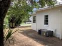 Home exterior featuring an AC unit and lamp with landscaping, showing the side of the home at 200 W Doane Ave, Eustis, FL 32726