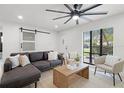 Bright living room with modern finishes, stylish furnishings, and a large window showcasing the outdoor view at 2932 Carriage Dr, South Daytona, FL 32119
