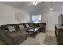 Cozy living room with vaulted ceiling, plush sectional sofa, and stylish decor, perfect for relaxation at 5123 Pineland Ave, Port Orange, FL 32127