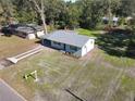 Expansive aerial view of the home with a long driveway and surrounding greenery at 611 S Montgomery Ave, Deland, FL 32720
