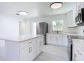 Bright kitchen featuring white cabinets, stainless steel appliances, and a center island at 611 S Montgomery Ave, Deland, FL 32720