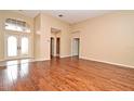 Spacious living room featuring hardwood floors, neutral paint, and arched doorways that create an airy atmosphere at 643 Cricklewood Ter, Lake Mary, FL 32746