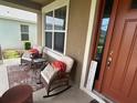 Inviting front porch with rocking chairs, creating a cozy outdoor seating area at 1166 Heron Sound Dr, Apopka, FL 32703