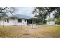 Fenced backyard featuring a screened-in lanai, a storage shed, and ample space for outdoor enjoyment at 15683 Sw 46Th Cir, Ocala, FL 34473