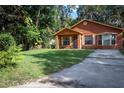 Quaint home with covered porch, green lawn, and concrete driveway at 1603 15Th, Sanford, FL 32771