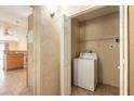 A utility area with a washing machine and storage space at 1710 Espanola Ave, Daytona Beach, FL 32117