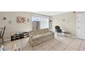 Neutral living room featuring sliding door to patio and comfortable seating at 202 Georgetown Dr # C, Casselberry, FL 32707