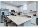 Kitchen featuring stainless steel appliances, white cabinets, and a center island with seating at 2043 Rock Maple Bnd, Kissimmee, FL 34746