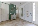 Welcoming entryway featuring green accent wall, modern tile flooring, and white doors at 2662 Roadster Ln, Kissimmee, FL 34746