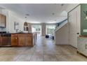 Bright living room with tile floors, and sliding glass doors to a screened patio at 2662 Roadster Ln, Kissimmee, FL 34746