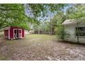 Spacious backyard featuring a storage shed, well-maintained lawn, and wooden fence at 2942 N Chickasaw Trl, Orlando, FL 32817