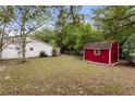 Spacious backyard featuring a storage shed, well-maintained lawn, and mature trees at 2942 N Chickasaw Trl, Orlando, FL 32817
