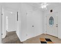 Bright entryway featuring paneled walls, unique flooring, and a decorative front door at 317 Benton St, Orlando, FL 32839