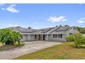 Spacious home boasts solar panels, a large driveway, and a well-manicured lawn at 317 Benton St, Orlando, FL 32839