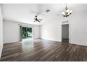Bright living room with hardwood floors and sliding glass doors to the backyard at 5671 Sycamore Canyon Dr, Kissimmee, FL 34758