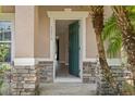 Inviting entryway featuring a green front door and a stone-accented facade at 1030 Bending Oak Trl, Winter Garden, FL 34787