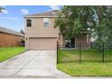 Exterior view of a two-story home with a two car garage and long driveway at 1030 Bending Oak Trl, Winter Garden, FL 34787