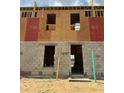 Townhome under construction, showcasing blockwork and framing on a sunny day at 15052 Grove Lake Dr, Winter Garden, FL 34787