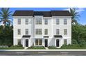 Modern townhome facade with a mix of white siding and brick accents for stylish curb appeal at 15052 Grove Lake Dr, Winter Garden, FL 34787