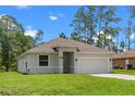 Attractive one-story home with a lush green lawn and an attached two-car garage at 1765 9Th Ave, Deland, FL 32724