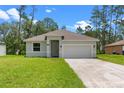 Inviting single-story home with a well-manicured lawn and convenient two-car garage at 1765 9Th Ave, Deland, FL 32724