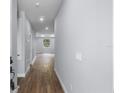 Inviting hallway with wood-look floors and neutral paint, leading to a bright living area at 1765 9Th Ave, Deland, FL 32724