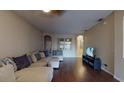 Spacious living room featuring hardwood floors and a large sectional sofa at 3552 Macauley Ct, Ocoee, FL 34761