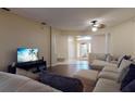 Inviting living room with hardwood floors, comfortable seating, and a modern TV at 3552 Macauley Ct, Ocoee, FL 34761
