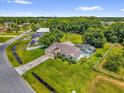 Aerial view highlighting the property with a screened-in pool, and a large backyard bordered by mature trees at 3750 Oak Pointe Blvd, Kissimmee, FL 34746