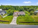 Expansive aerial view showcases the home's generous lot size and lush green landscaping with mature trees at 3750 Oak Pointe Blvd, Kissimmee, FL 34746