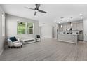 Bright, open-concept living room featuring tile floors, recessed lighting, and a ceiling fan at 4028 Southern Vista Loop, St Cloud, FL 34772