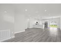 An open-concept living room features gray floors, recessed lighting, and an open kitchen at 4662 Sw 136Th St, Ocala, FL 34473