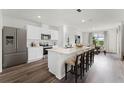 Modern kitchen features stainless steel appliances, a spacious island with seating, and an open layout at 5120 Gopher Apple Dr, Apopka, FL 32712