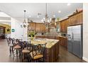 Gourmet kitchen with granite countertops, custom cabinetry, stainless steel appliances, and decorative lighting at 8424 Lake Burden Cir, Windermere, FL 34786