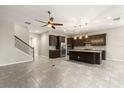 Open kitchen featuring dark wood cabinets, a stainless-steel refrigerator, an island, and tile backsplash, and is open to a stairwell at 1046 Grand Hilltop Dr, Apopka, FL 32703