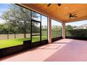 Covered lanai featuring a wood ceiling, ceiling fan, and views of the backyard and landscaping at 1046 Grand Hilltop Dr, Apopka, FL 32703