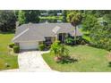 Beautiful home featuring lush landscaping, driveway, lawn and an inviting entry way at 1125 Almond Tree Cir, Orlando, FL 32835