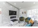 Welcoming living room features a modern fireplace, large TV, and comfortable seating arrangement at 18623 Tunbridge St, Orlando, FL 32833