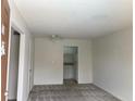 View of the living room with grey carpet leading to the kitchen with white cabinets at 2525 Caper Ln # 205, Maitland, FL 32751