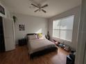 Cozy bedroom featuring wood floors, a ceiling fan, and natural light from a window with blinds at 2740 Maitland Crossing Way # 2-303, Orlando, FL 32810