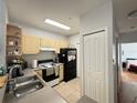 Functional kitchen featuring wood cabinets and essential appliances for convenient meal preparation at 2740 Maitland Crossing Way # 2-303, Orlando, FL 32810