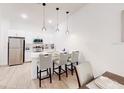 Bright kitchen boasts modern white cabinets, stainless appliances, and a breakfast bar with pendant lighting at 359 Famagusta Dr, Davenport, FL 33896