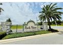 Park View at the Hills community entrance sign surrounded by lush landscaping and a stone wall at 451 Lemongrass Rd, Minneola, FL 34715