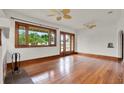 Bright living room with hardwood floors, large windows, ceiling fans, and classic archway at 1013 W 20Th St, Sanford, FL 32771