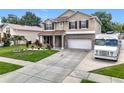 Charming two-story home with a two-car garage, landscaped front yard, and extended driveway at 238 Hunt St, Clermont, FL 34711
