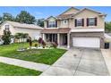 Two-story home with landscaped yard, brick accents and a spacious driveway at 238 Hunt St, Clermont, FL 34711